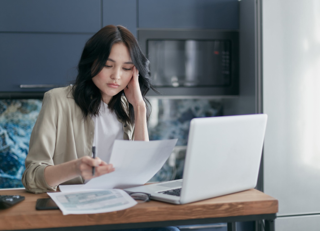 Stressed Woman Looking at Paperwork